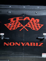 a black trailer with a red and black flag on it