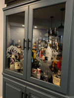 a cabinet with a lot of liquor bottles in it