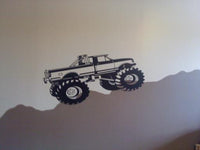 a black and white picture of a monster truck on a wall