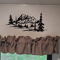 a window with a valance with a mountain scene on it