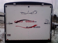 a white trailer with red writing on the side of it