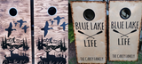 a pair of cornhole game boards with the words blue lake and life painted on