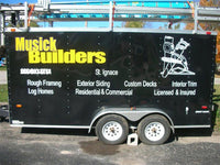 a black trailer with white lettering on the side of it