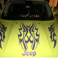 the hood of a yellow jeep with flames on it