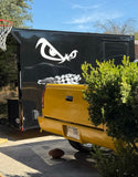 a yellow truck parked in front of a basketball hoop