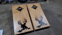 a pair of cornhole boards with a picture of a deer