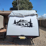 a camper trailer parked in a gravel lot