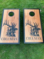 two cornhole game boards with a picture of a deer and the name coleman