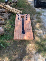 a wooden board with a guitar on it