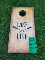 a wooden sign sitting on top of a lush green field