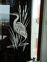 a black and white picture of a bird on a window sill