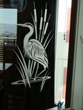 a black and white picture of a bird on a window sill