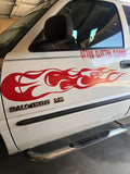 a white truck with a red flame decal on the side of it