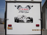 the back of a truck with a racing car painted on it