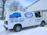 a white van parked in front of a building